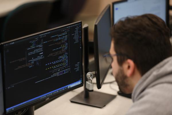 Male student programming in a computer lab
